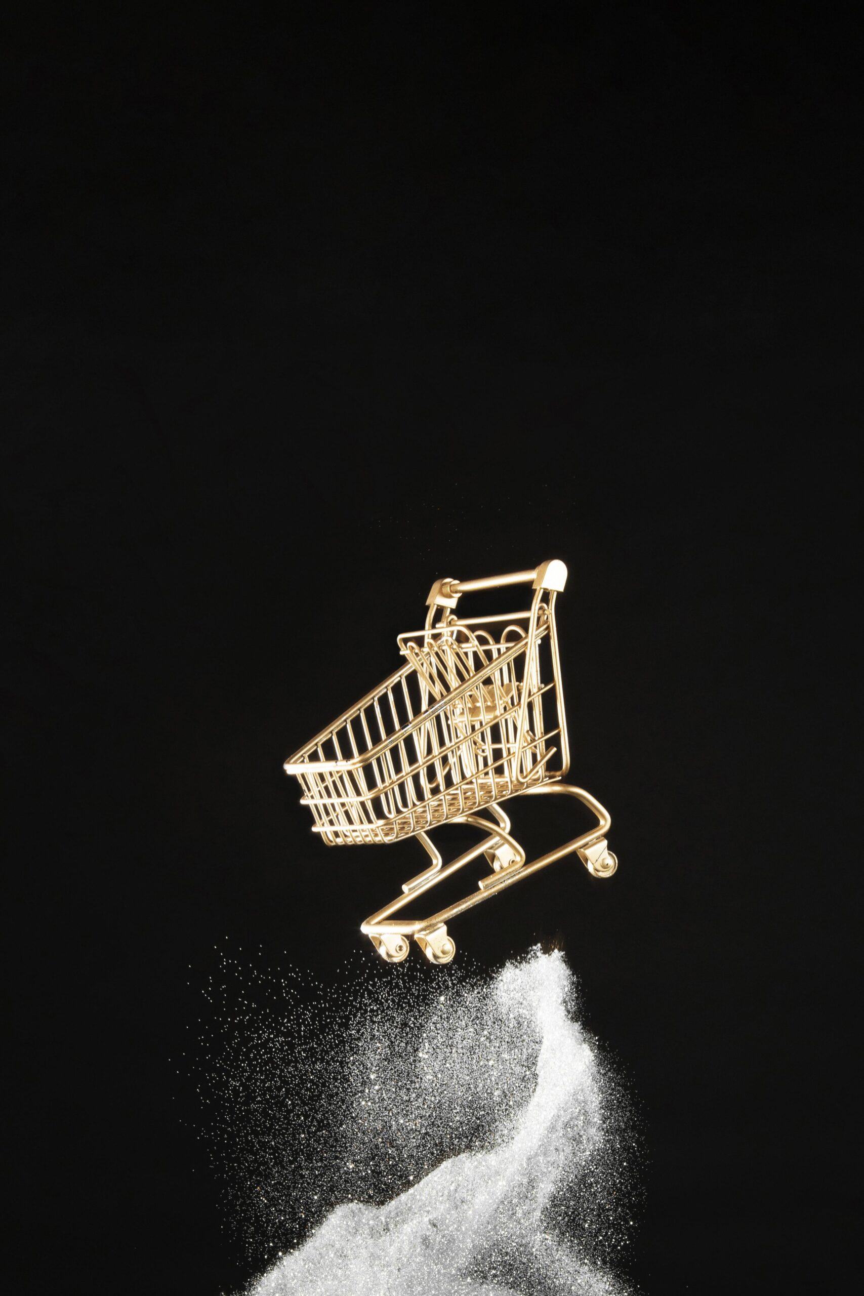 golden shopping cart white glitter black background scaled