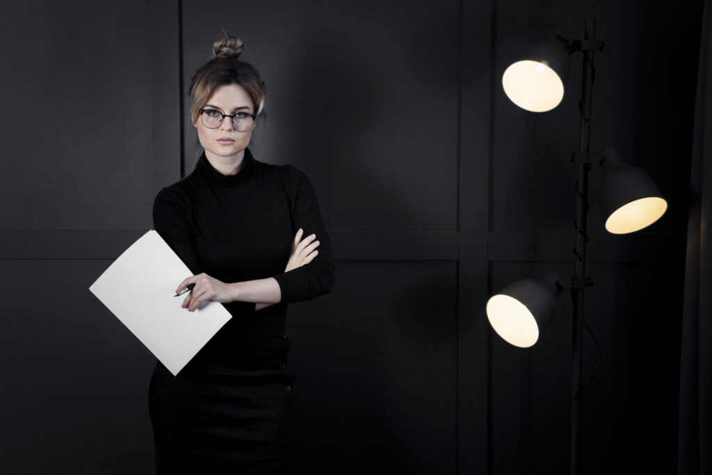 corporate young woman with eyeglasses holding papers