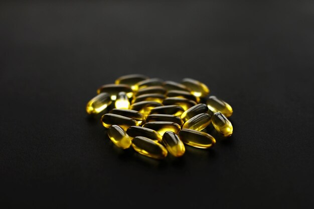 omega 3 capsules black dark background dietary supplements fish oil pills health support treatment biologically active additives vitamin nutrient tabletsxa 250813 4726