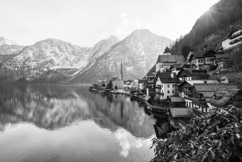 beautiful shot small village surrounded by lake snowy hills